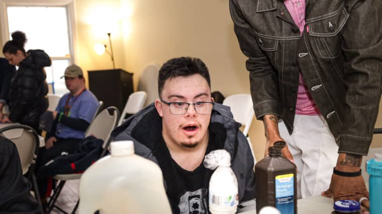 A person supported by AHRC Nassau looks at the science station at Wheatley Farms & Arts Center