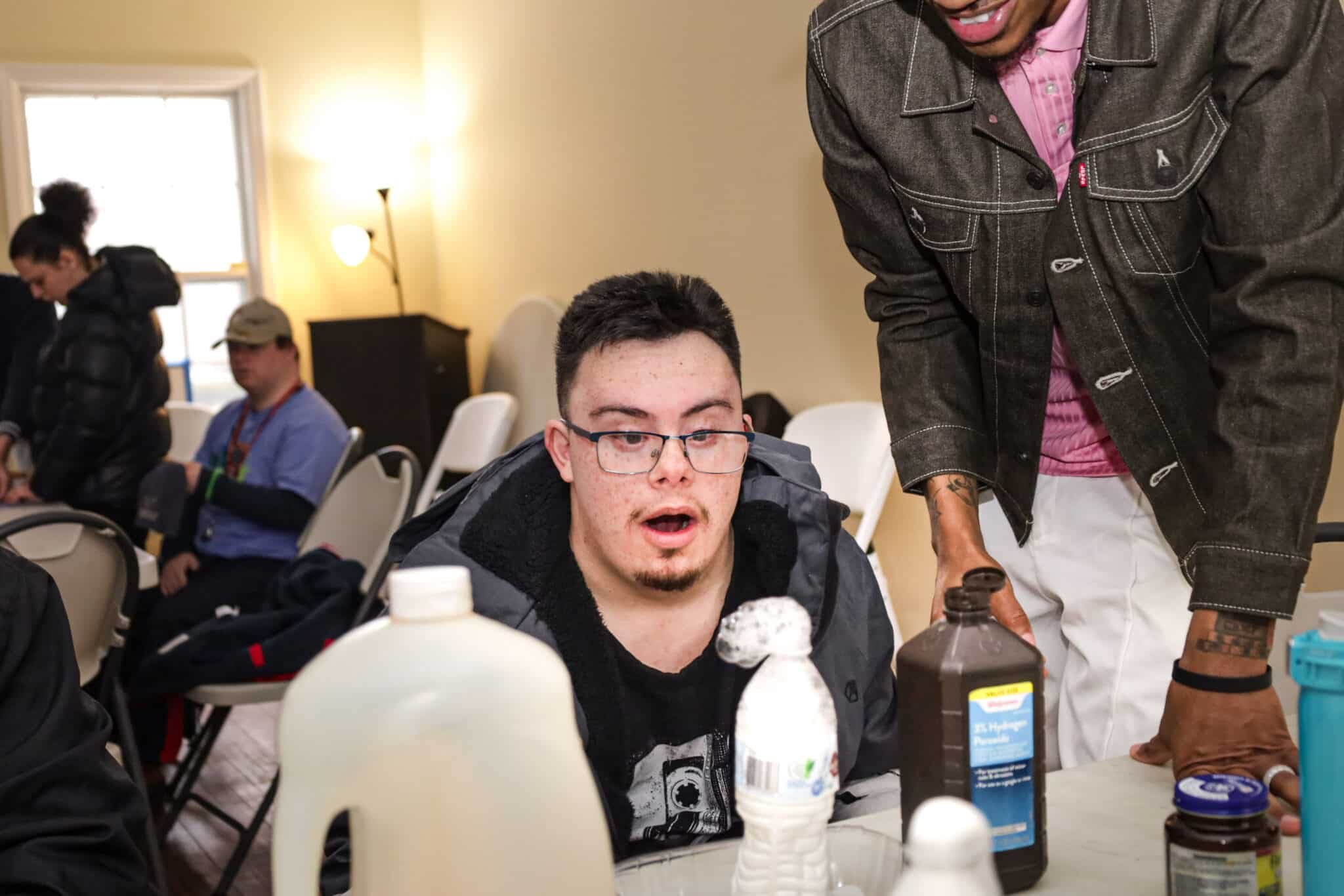 A person supported by AHRC Nassau looks at the science station at Wheatley Farms & Arts Center