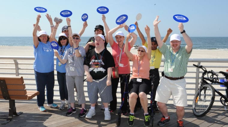 A group from AHRC Nassau cheers on the Long Beach boardwalk.