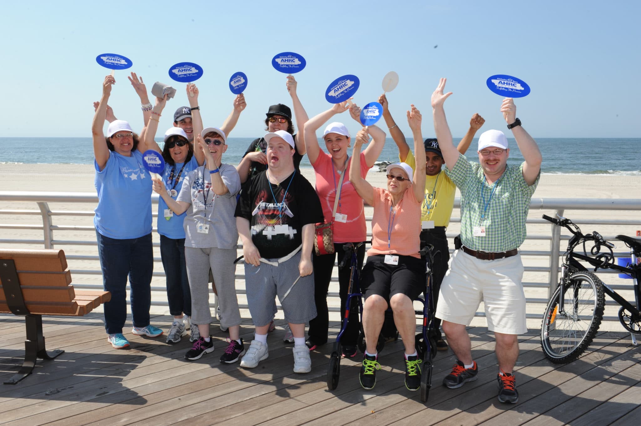 A group from AHRC Nassau cheers on the Long Beach boardwalk.