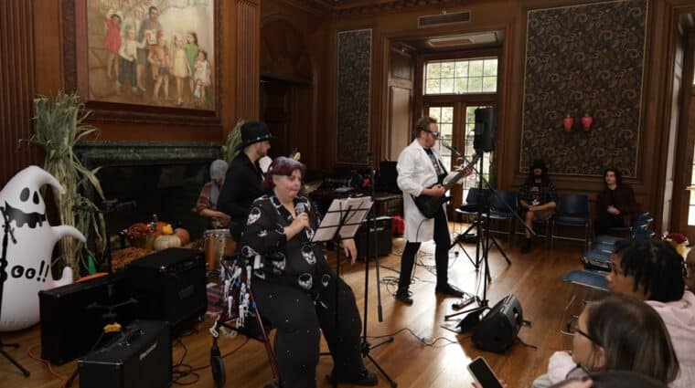 Coleen Mackin sings wit a backing band at her Halloween event