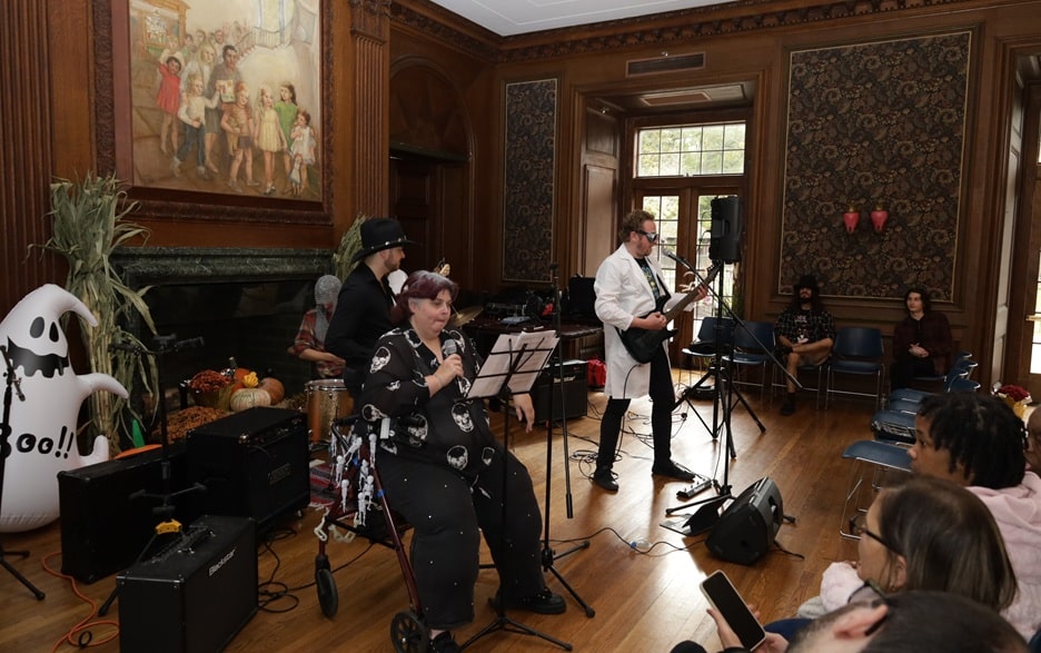 Coleen Mackin sings wit a backing band at her Halloween event