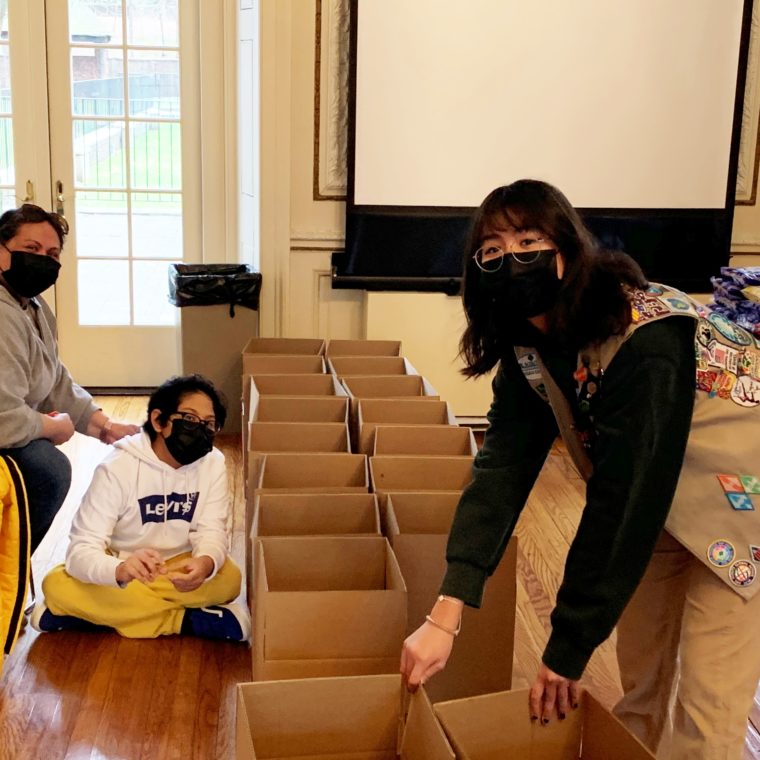 Girl scout prepares to load boxes