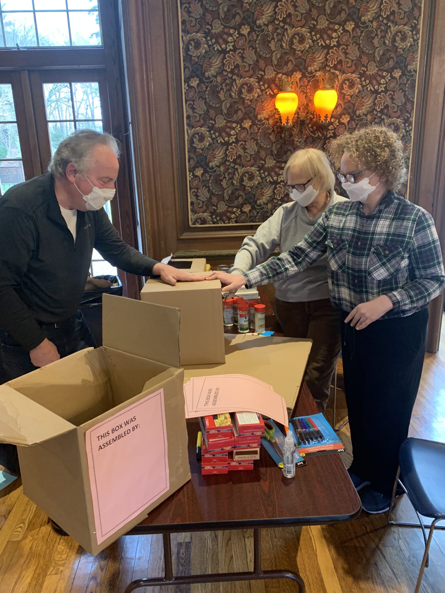 Volunteer family prepares boxes