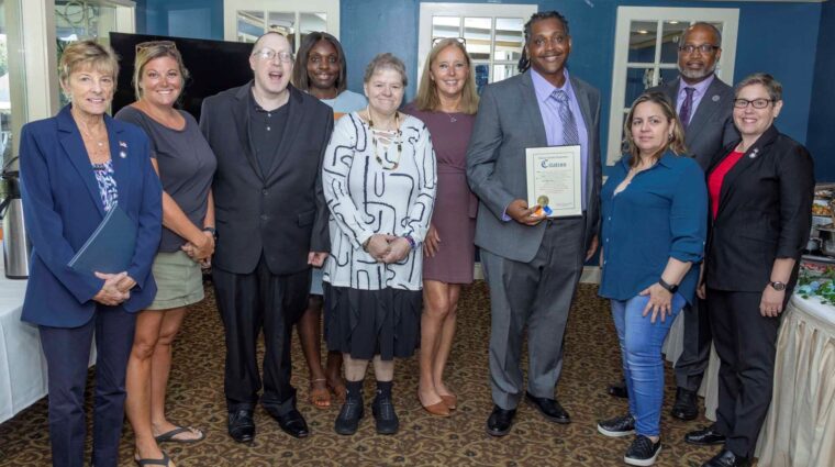 Residential Managers pose with Direct Support Professionals at a celebratory brunch