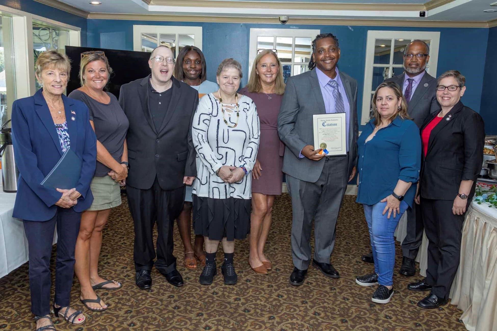 Residential Managers pose with Direct Support Professionals at a celebratory brunch