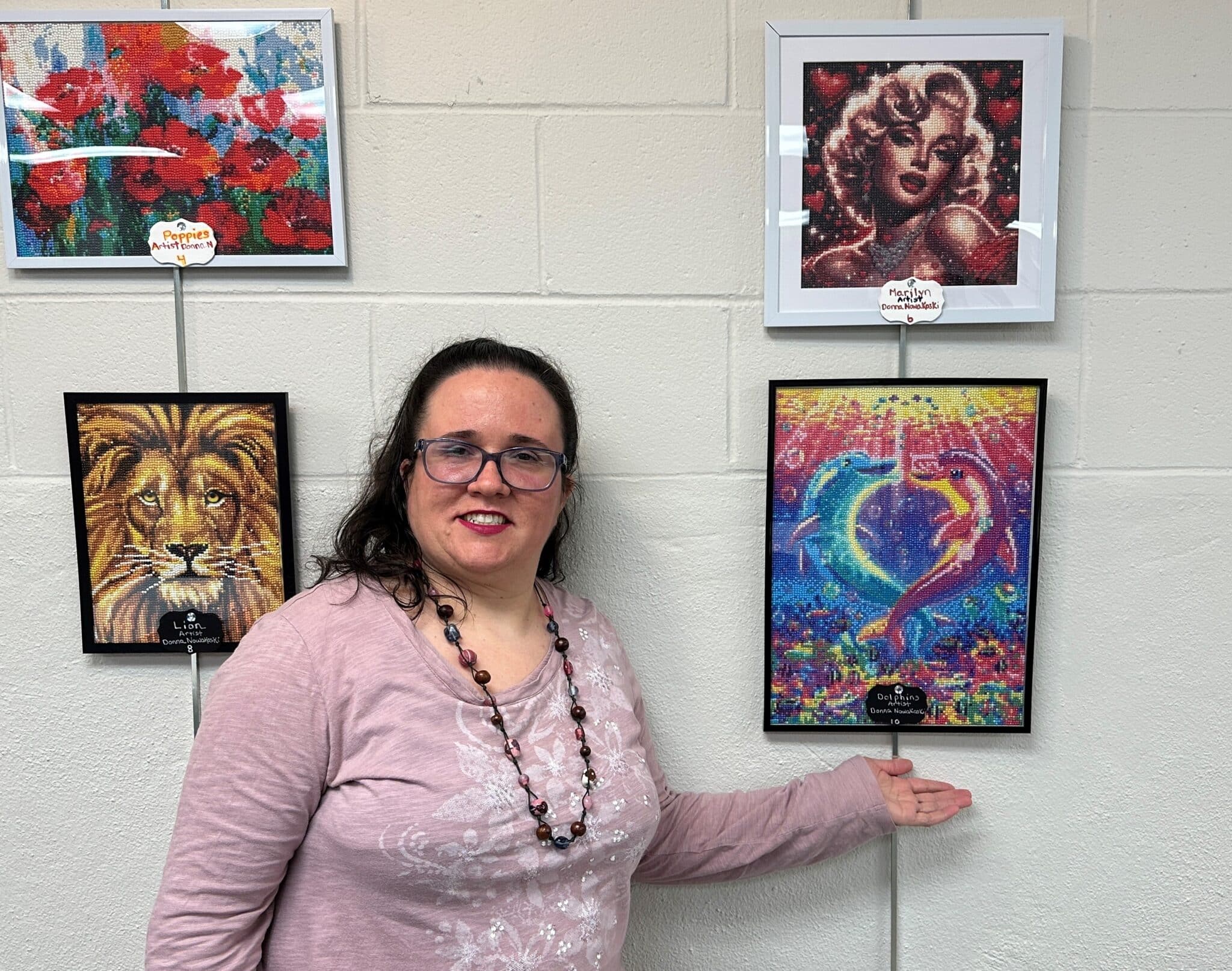 Donna Nowakowski shows off one of her pieces of art