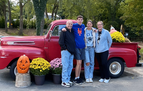 A family poses in front of a vintage truck at the Wheatley Farms Fall Festival