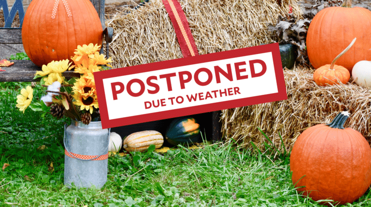 Photo of pumpkins and other fall decoration with a POSTPONED stamp on it