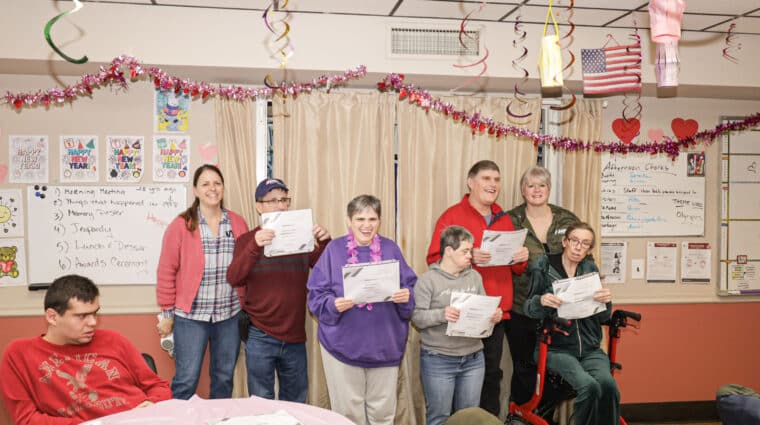 Farmingdale 1 residents hold up their certificates.
