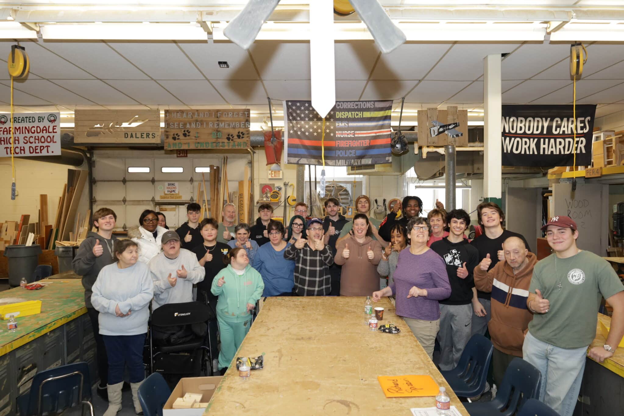 Farmingdale High School students and people supported by AHRC Nassau in the woodshop.