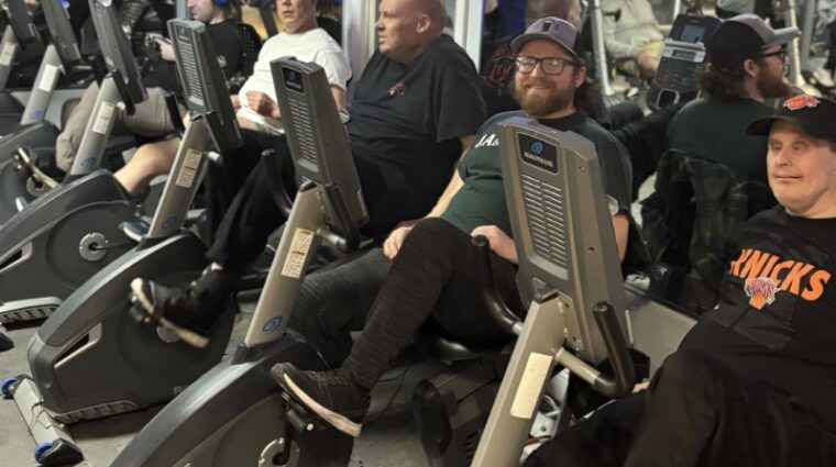 Residents of Old Britton ride stationery bikes together at HOPEFitness Sports Foundation