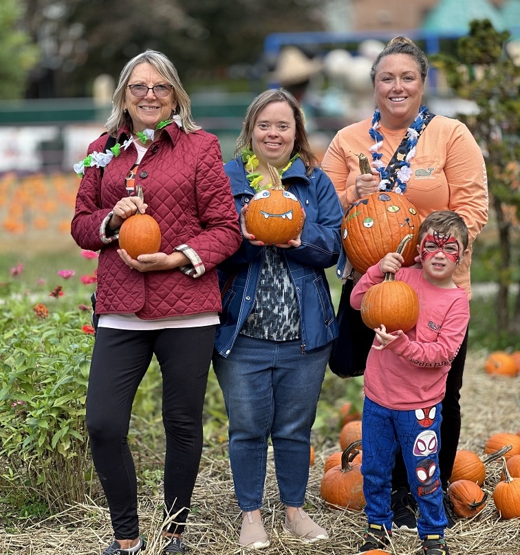 A family picks pumpkins at the Wheatley Farms Fall Festival