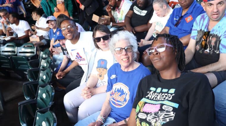 People supported by AHRC Nassau and DSPs enjoy a Mets game.