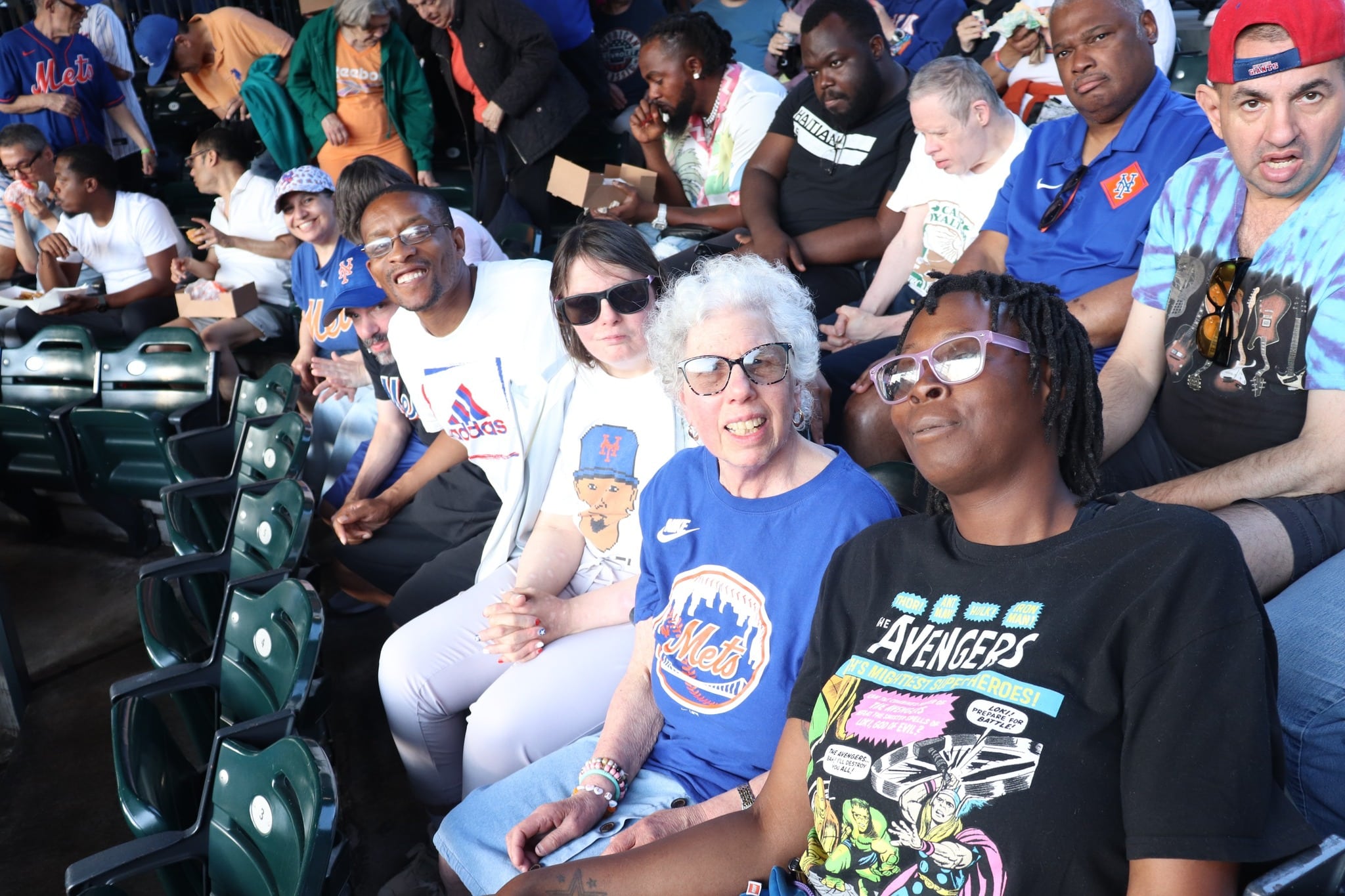 People supported by AHRC Nassau and DSPs enjoy a Mets game.