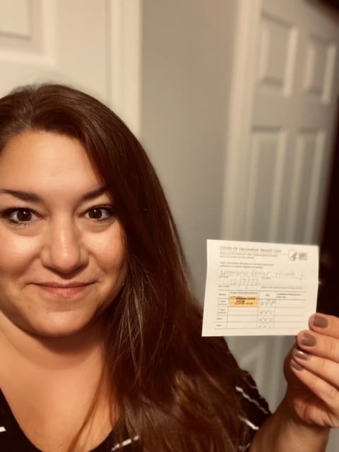 Nicole Uterano Ferrar shows vaccination card