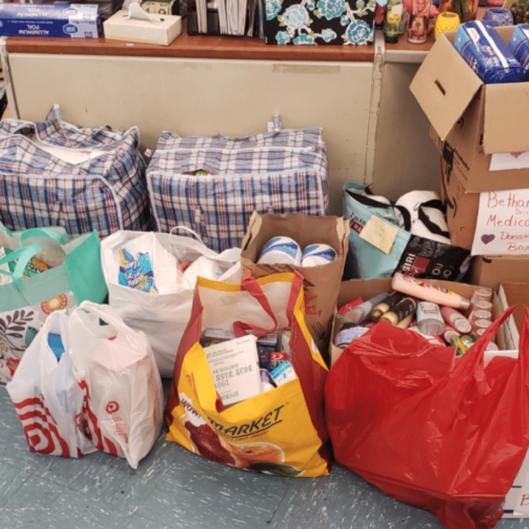 Bags of toothpaste, toothbrushes, toilet paper, shampoo and other donations for Bethany House