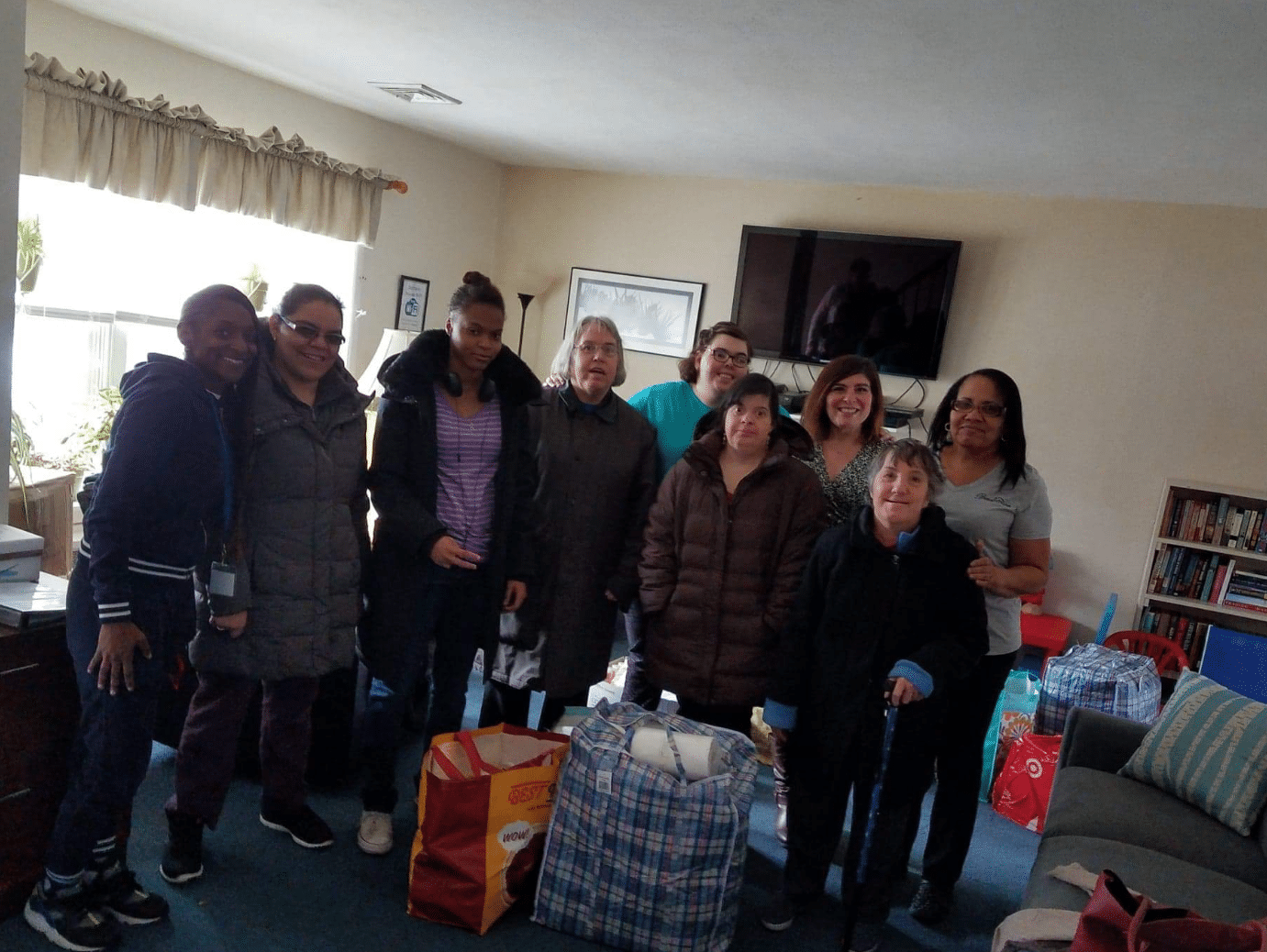 Amanda Brosnan gathers with AHRC Nassau staff and Bethany House staff members for a photo with donations