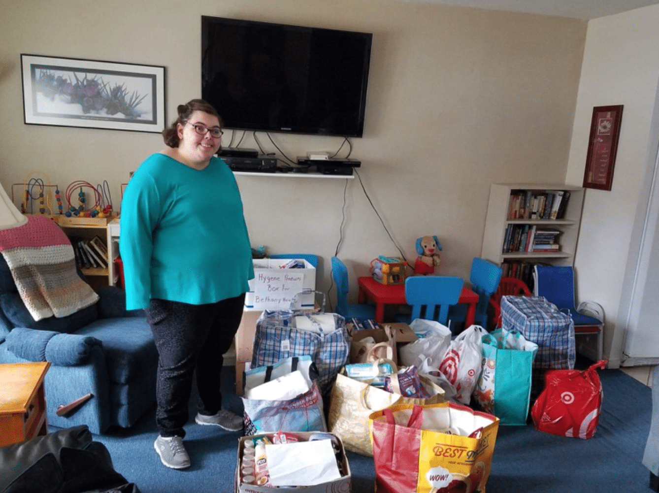 Amanda Brosnan stands next to bags of donations to support Bethany House, a local non-profit