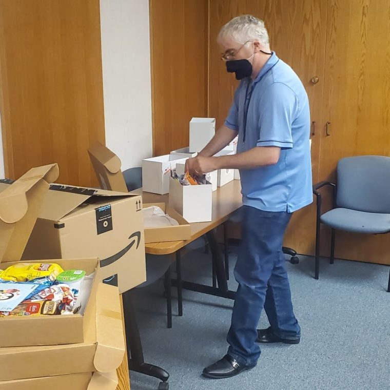 AHRC admin prepares a sunshine bag for staff