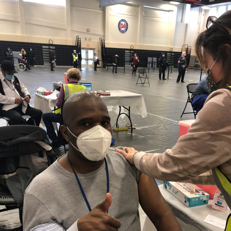 Executive Director Stanfort Perry receives the vaccine.