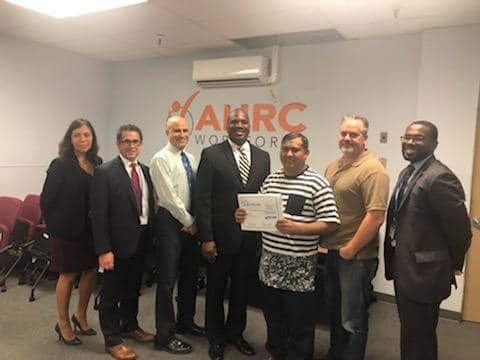 Abrar Butt is recognized by NYSID for employment excellence. He is pictured with AHRC Nassau Executive Director Stanfort Perry and other staff from the AHRC Nassau team.