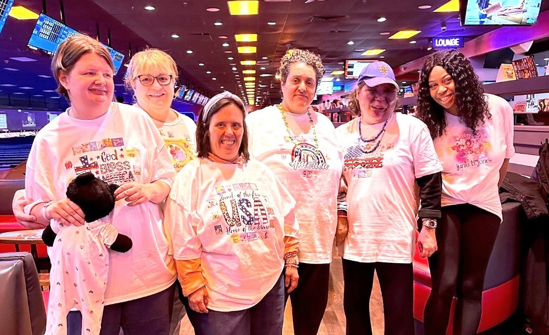 A photo of six people at a bowling alley