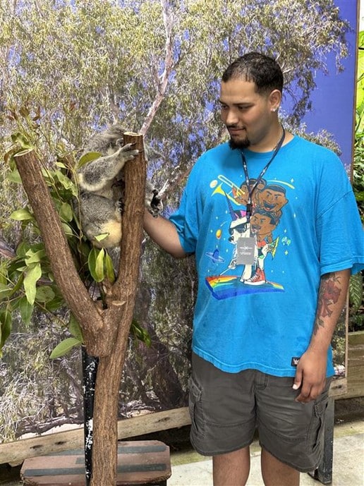 Kyle with a Koala in Australia, where he visited as his Personal Outcome Goal.