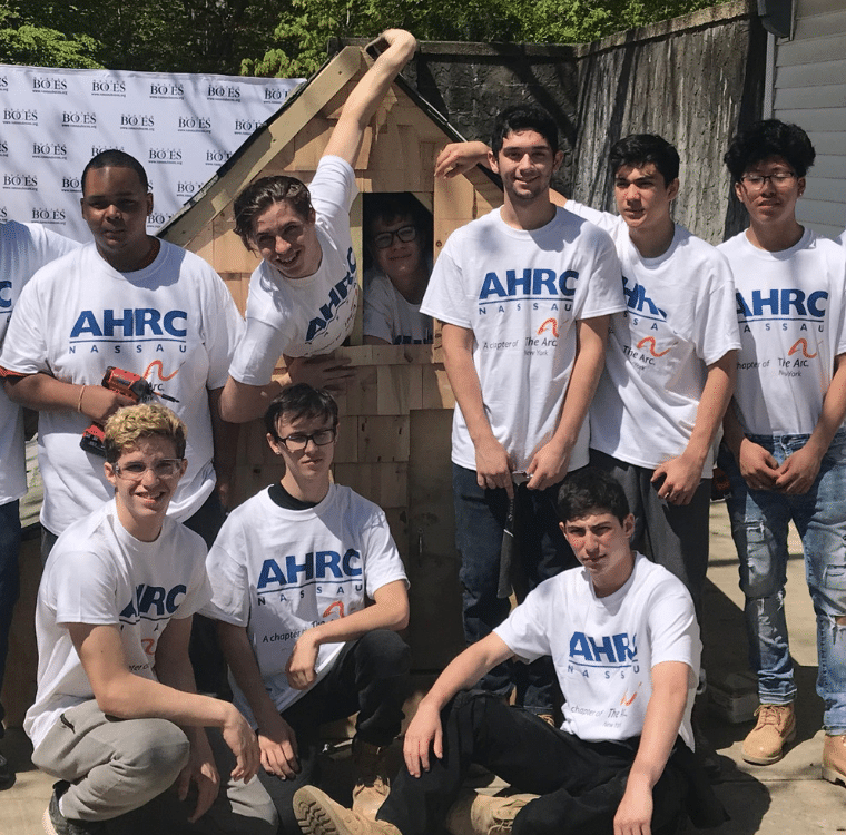 Students from Nassau BOCES gather around completed chicken coop project