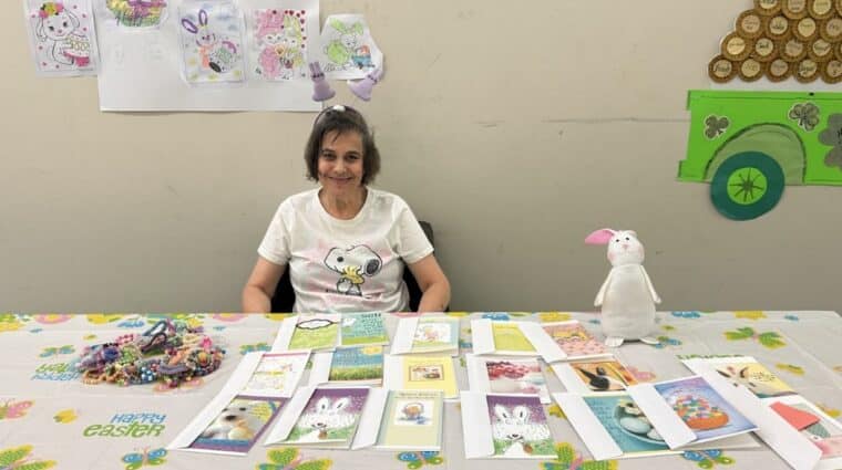 Christine Marra poses with some cards that she designed for Easter