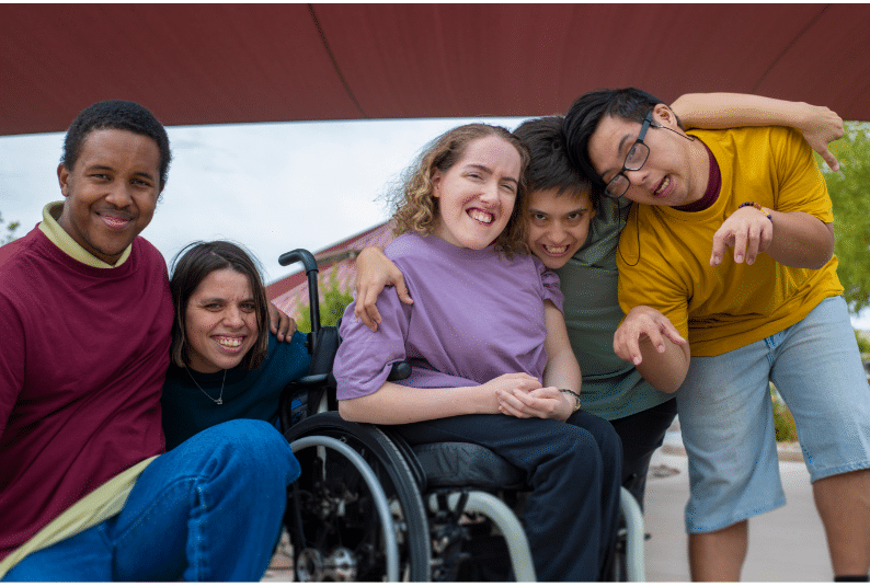 A diverse group of people pose for a photo