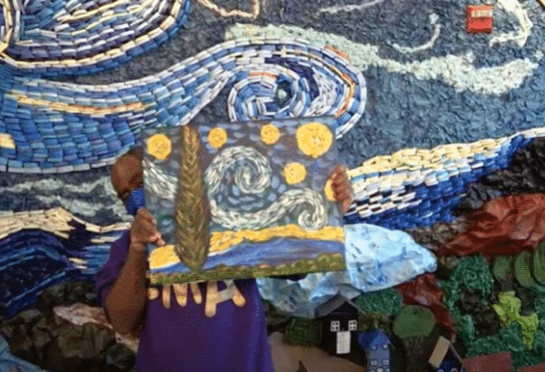 Artist Douglas shows a piece from the "Starry Night" exhibit