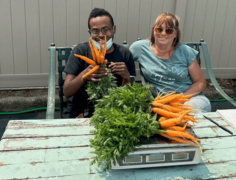 Volunteers and AHRC Pre-Voc Services help measure carrots as part of food insecurity initiative