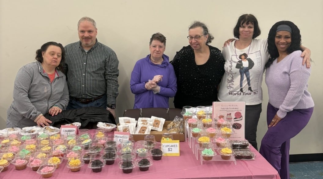 Members of the AHRC Nassau community hosting a bake sale.