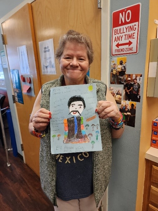 Three people supported by AHRC Nassau and members of the Hooked on Books reading club show off their art and their certificates.