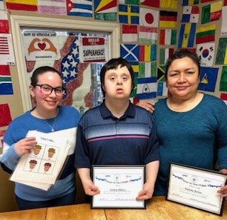 James Miklos pictured with two AHRC Nassau staff members