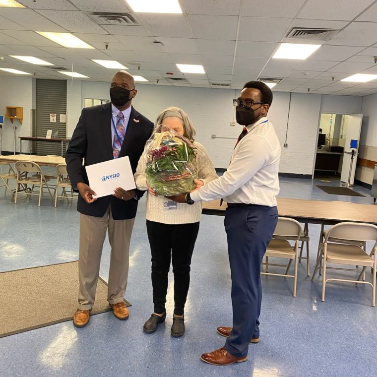 Margaret Baylis with AHRC Nassau Executive Director Stanfort Perry (left) and Employment Services Director Justin Dantzler (right)