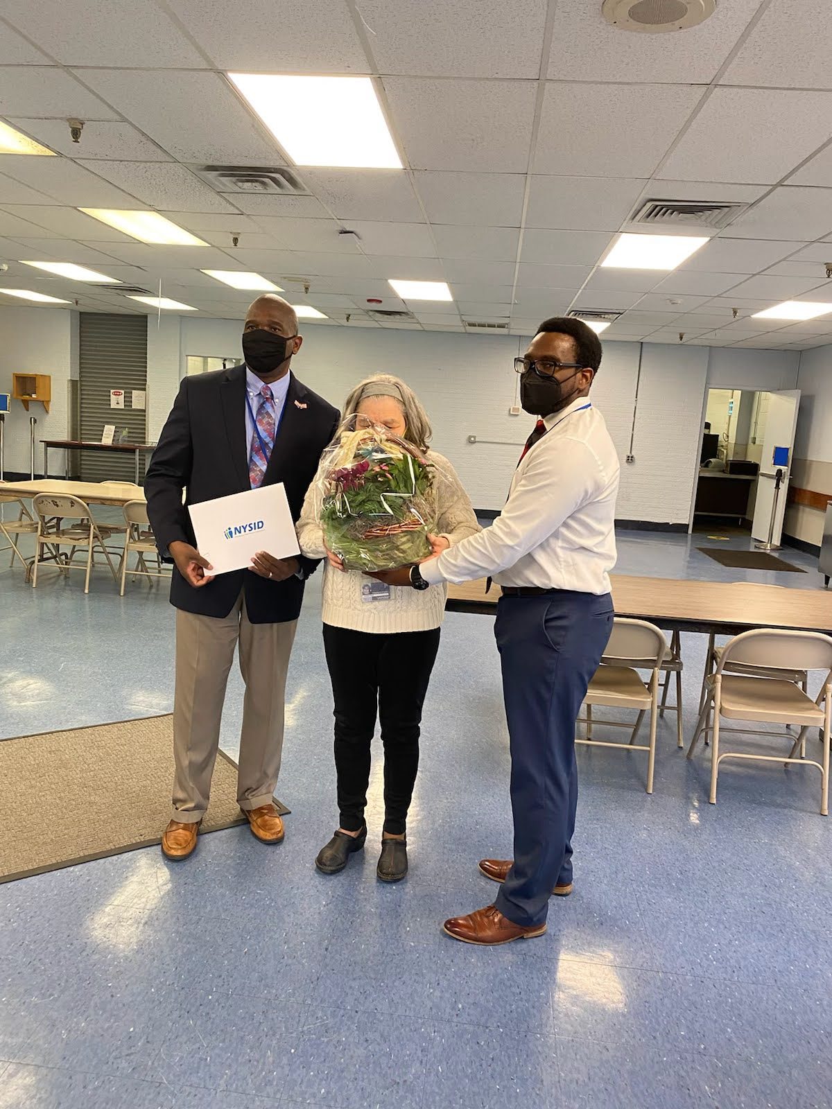Margaret Baylis with AHRC Nassau Executive Director Stanfort Perry (left) and Employment Services Director Justin Dantzler (right)