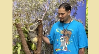 Kyle with a Koala in Australia, where he visited as his Personal Outcome Goal.