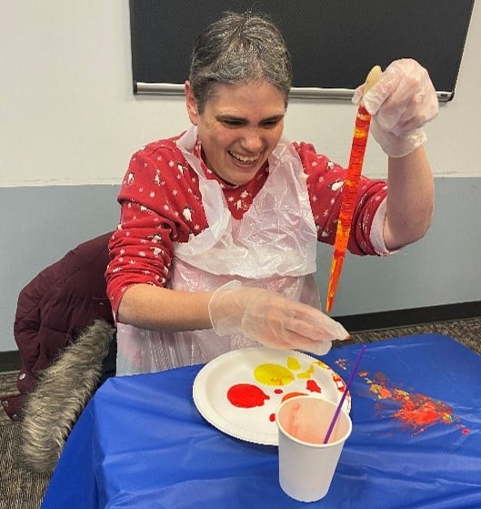 A person supported painting a snake at the Lunar New Year event.