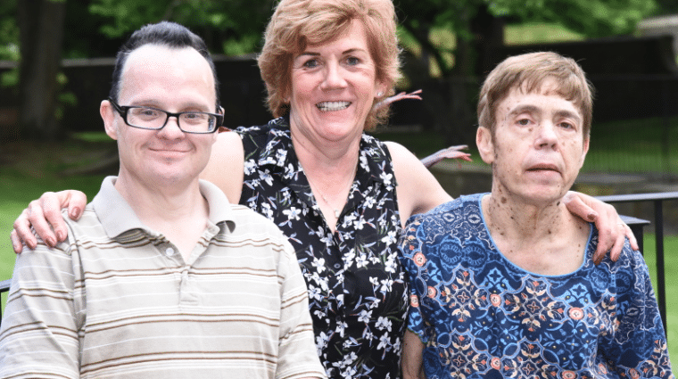 AHRC Nassau's Lynne Brewer helps her friend Billy Meyer have a lifetime of memories in 18 months. She is pictured standing with Billy and her sister, Diane.