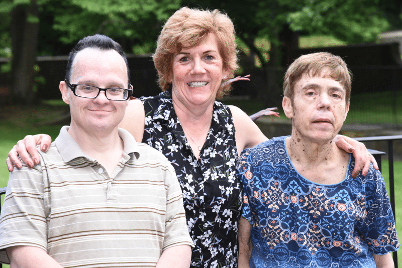 AHRC Nassau's Lynne Brewer helps her friend Billy Meyer have a lifetime of memories in 18 months. She is pictured standing with Billy and her sister, Diane.