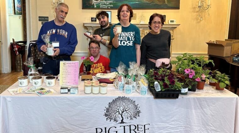 Five men and women receiving pre-voc services selling flowers and other gifts for Mother's Day.