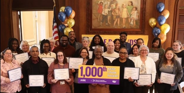 Our 1000th DSP to receive an E-Badge certification poses with other recipients