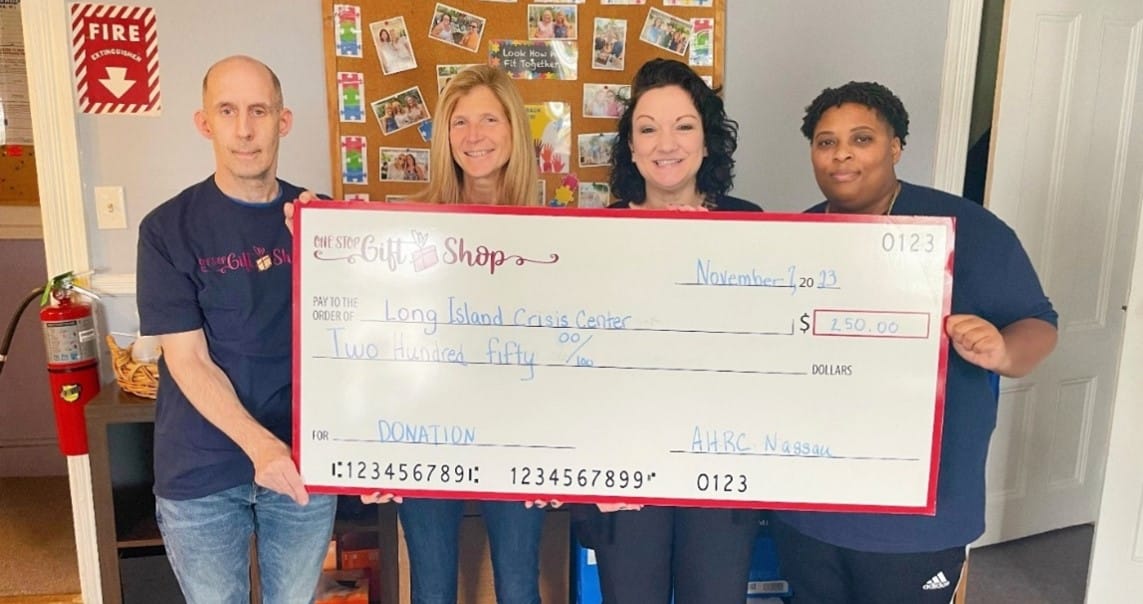 One Stop Gift Shop Volunteers pose with their donation check