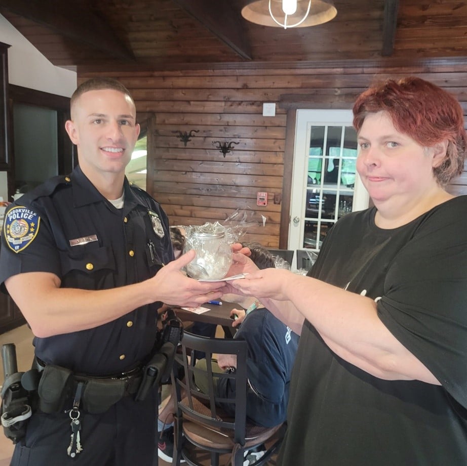 Coleen Mackin poses with a police officer at the emergency preparedness event for Patriot Day.