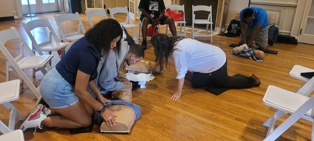 People supported learn CPR as part of the emergency preparedness event for Patriot Day.