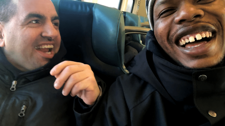 Derek Carney and Direct Support Professional Greg Sanniez laugh and enjoy their time on the Long Island Railroad.