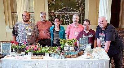 Members of our Pre-Vocational program pose for a photo in front of their pop-up shops for Wheatley Farms
