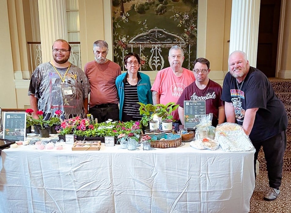 Members of our Pre-Vocational program pose for a photo in front of their pop-up shops for Wheatley Farms
